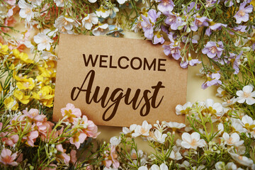 Welcome August text message with flower decoration on yellow background