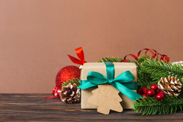 New Year Christmas mood, gift box, branches of a christmas tree, New Year decorations on a colored background