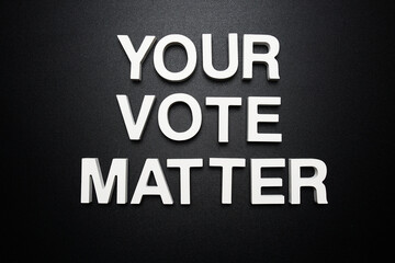 Your Vote Matters alphabet letter on black background