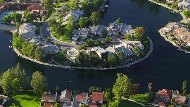 Aerial view of luxury private property at Lake Calabasas, Los Angeles suburban, USA. Drone shot of expensive villas settled around picturesque landscape. Wealthy community in suburban neighborhood