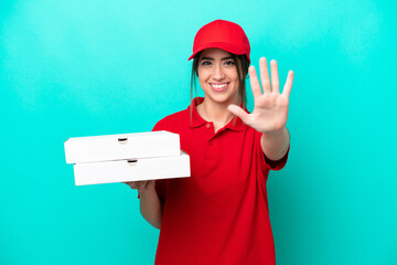 Pizza delivery woman with work uniform picking up pizza boxes isolated on blue background counting...