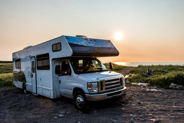 Camper RV truck parked at the Cape Breton Island Coast line Sunset cliff scenic Cabot Trail Nova Scotia Hghlands Canada