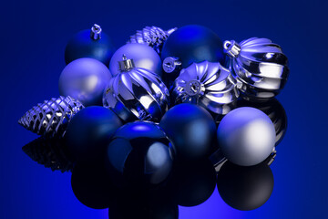 Christmas and New Year blue and silver color baubles decoration background. Art design backdrop with holiday balls. Beautiful Christmas ball closeup  