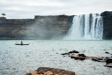 5th December, 2023, Jagdalpur, Chattisgarh, India: A fisherman fishing at a beautiful Chitrakote water falls at Jagdalpur, Chattisgarh, India.