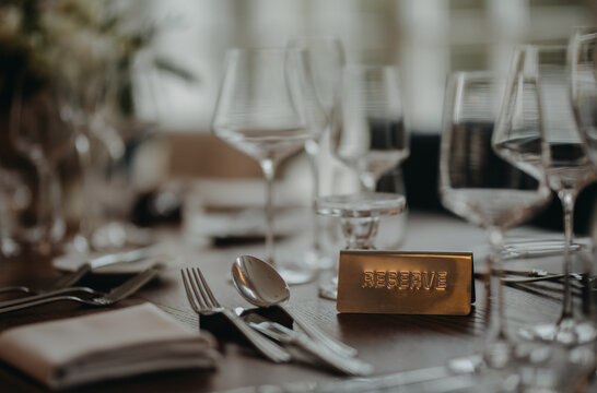Reservation on table, reserved table sign, plate. Elegant, romantic table setting for indoor wedding reception. or for restaurant.