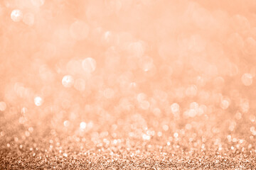 Diamond coral bokeh texture with sparkling particles festive background in color of the year 2024...