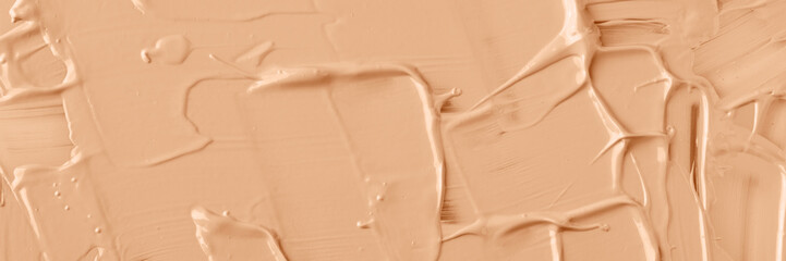 Texture of liquid foundation in color of the year 2024 Peach Fuzz, banner