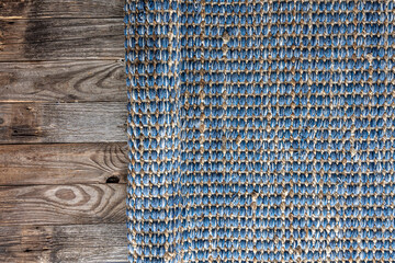 Hand woven geometric denim area rug, jute braided home background texture.