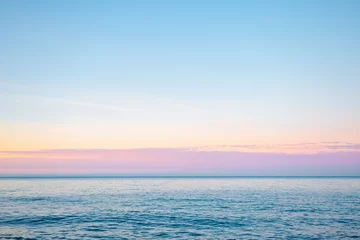 Foto op Aluminium Horizontal line of calm sea in soft morning light. Sicily, Italy, Europe. © Leonid Tit