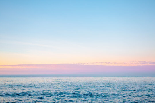 Horizontal line of calm sea in soft morning light. Sicily, Italy, Europe.