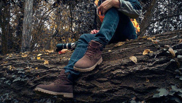 Man wearing boots in autumn season. - Powered by Adobe