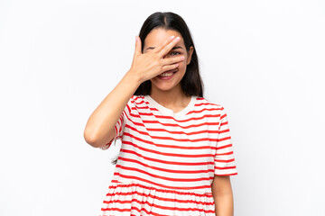 Young Colombian woman isolated on white background covering eyes by hands and smiling