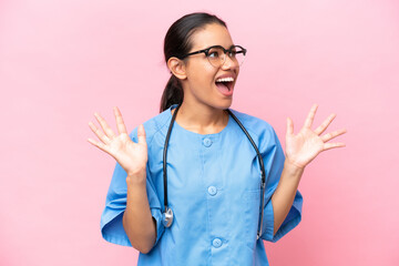 Young nurse Colombian woman isolated on pink background with surprise facial expression