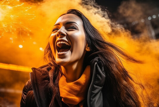 Happy girl fan at a football stadium screams and rejoices at the victory of her team