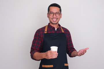 A barista smiling happy while holding a cup of coffee