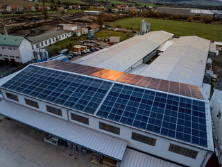 Aerial view of solar panels on a rooftop of factory. Solar energy as renewable energy source in business. © Halfpoint