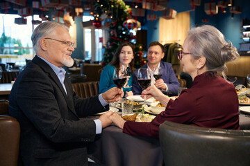 Happy family celebrating winter holidays in the restaurant
