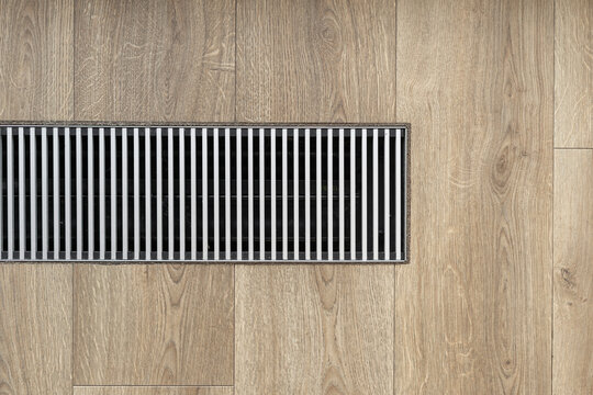 Close up of heating system in wooden floor at home