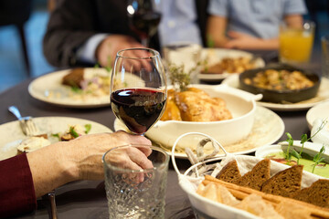 Hand of old woman holding glasses of wine, enjoying of celebration