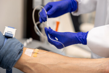 Inserting catheter into vein in patient's arm in hospital medicinal solution intravenously.