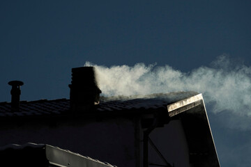 Fireplace House smoke from chimney in winter season close up