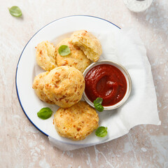 Homemade cheese scones with tomato sauce