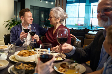 Man and woman toasting, celebrating winter holidays