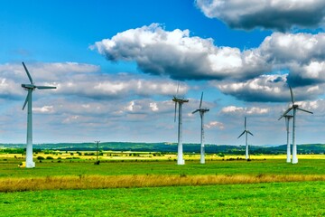 Wind turbines in autumn landscape. Alternative energy source for electricity production.	