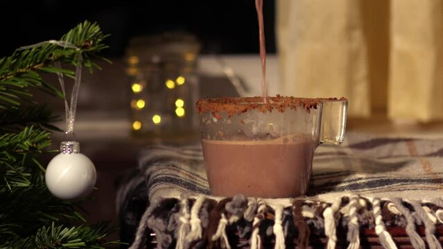 Pouring Hot Chocolate drink in Christmas festive scene 