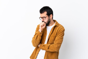 Caucasian handsome man with beard wearing a corduroy jacket over isolated white background is...