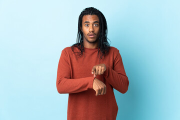 Delivery African American man with braids isolated on white background making the gesture of being late