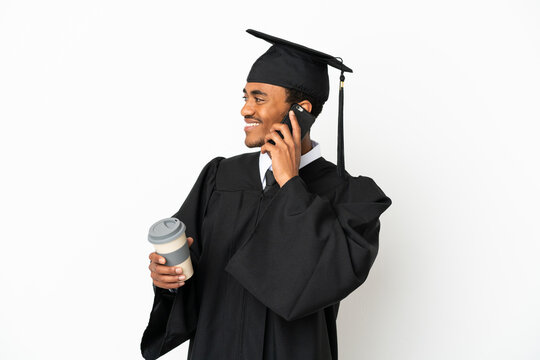 African American university graduate man over isolated white background holding coffee to take away and a mobile