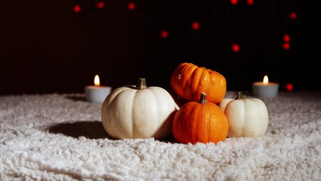 Autumn pumpkins with candles in warm background
