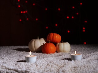 Autumn pumpkins with candles in warm background