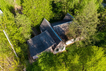 Aerial view of the roof of a wooden building in the middle of colorful trees
