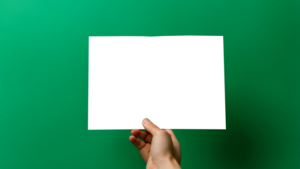 hand holds a sheet of paper on a green background