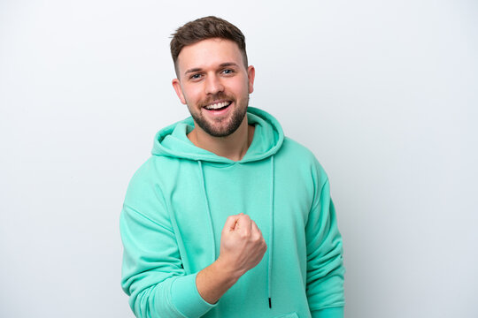 Young caucasian man isolated on white background celebrating a victory