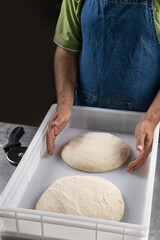 A baker prepares bread in the kitchen