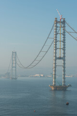Osman Gazi Bridge (Izmit Bay Bridge). Izmit, Kocaeli, Turkey. Construction of a new road bridge continues across the Marmara Sea.