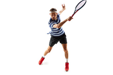 Ambitious and concentrated man, tennis player in motion, practicing, hitting ball with racket, training isolated over white background. Concept of sport, hobby, active, healthy lifestyle, competition