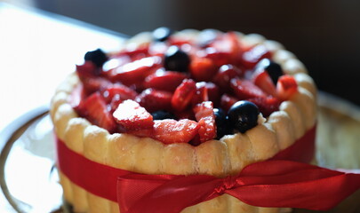 Delicious floury sweet cake with strawberries and currants. Cooking cake at home concept