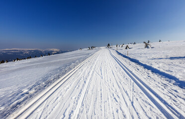 View of the winter mountain landscape from the ski path