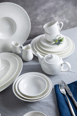 Dishes, plates, cups, spoons and forks in the kitchen