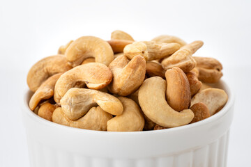 Cashew. Plant based ingredient. Dried cashew nuts. Macro shot. Raw snack. Pile cashew nuts without shell. Whole nut kernels. 