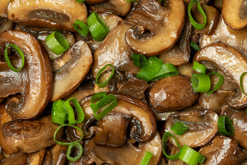 Close-up of fried cremini mushrooms topped with chopped green onion.  European healthy vegan dish....