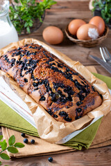 Home baked cake with blueberries on wooden table