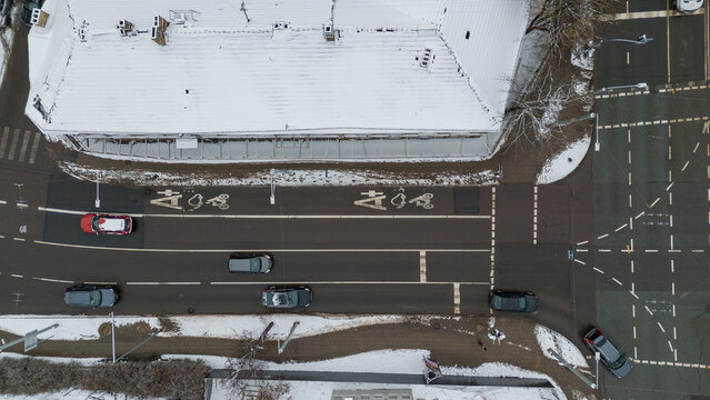 Drone photography of city street and surrounding buildings in snow