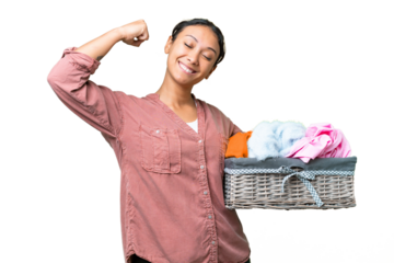 Young Uruguayan woman holding a clothes basket over isolated chroma key background doing strong gesture