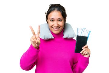 Young Uruguayan woman holding a passport over isolated chroma key background smiling and showing victory sign