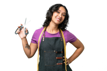 Young seamstress argentinian woman over isolated background posing with arms at hip and smiling